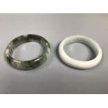 Two various jadeite bangles, the larger one 7cm diameter
