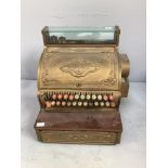 A National cash register, with ornate brass cast cover, back and sides, glass viewing box, 42cm