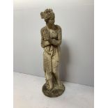 A reconstituted stone garden statue of Venus bathing, on circular base, 116cm high