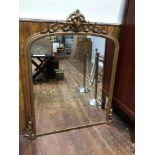 A Victorian large gilt and gesso framed over mantel mirror with arched top and interestingly