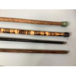 Four various walking sticks including two silver topped examples