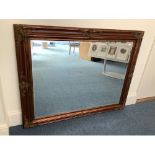 A large rectangular bevelled mirror in ornate gilt-wood and gesso frame with decorative moulded