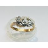 An 18ct yellow gold and platinum diamond ring, set with three round brilliant cut diamonds in an