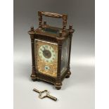 A brass carriage clock by Mappin and Webb, the exposed platform escapement above a gilt, arabesque