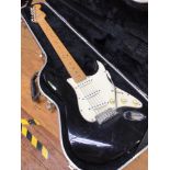 An American Fender Stratocaster, c.1993-94, the black body with white scratch-plate, tremolo arm and