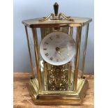 A German brass anniversary clock by Kundo, the dial with gilt Roman numerals, in hexagonal