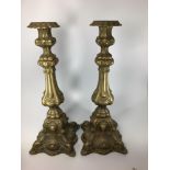 A pair of ornate cast brass candlesticks, approx. 40cm high