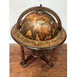 A 20th century drinks cabinet modelled as a terrestrial globe suspended on an axis, with outer