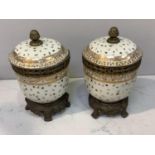 A pair of gilt metal-mounted porcelain ice pails and covers with acorn finials, gilt highlights with