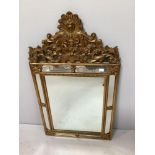 A reproduction Regency style gold mirror with decorative over panel and sectioned border 62cm wide