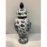 A large blue and white Ironstone 'style' baluster vase and cover, the entirety decorated with a