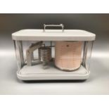 A 20th century barograph in glazed plastic case, raised on four supports, case measures 24cm