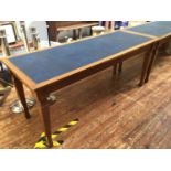 A pair of early 20th century stained mahogany library tables with blue blind-tooled inset leather