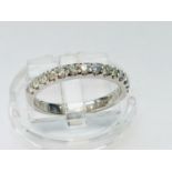 An 18ct white gold wedding ring set with 15 x round brilliant cut diamonds in a pave style