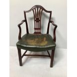 A George III mahogany shield back carver chair with floral carved crest rail, pierced splat,