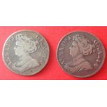 Two Queen Anne silver shillings dated 1711 (angles plain) and 1712 (roses and plumes), with the