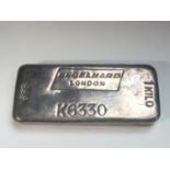 A solid 999 silver bar, stamped Engelhard London,weighs 1002 grams.