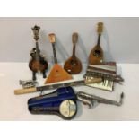 A collection of assorted musical instruments comprising a silver-plated pocket cornet by Bessons &