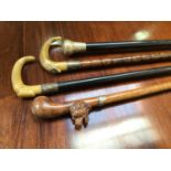 Four various walking sticks including a horn handled and silver collared partridge wood stick,