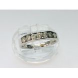 A 9ct white gold half eternity ring, set with 7 x round brilliant cut diamonds in a channel setting,