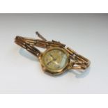 A lady's 9ct rose gold vintage wristwatch on 9ct gold expandable bracelet with chain safety catch,