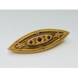 A 9ct gold Edwardian brooch, set with red stones and seed pearls, measurers 18mm x 7mm, weighs 4.1