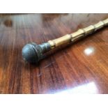 An unusual bamboo walking stick with globular pierced and scroll carved vinaigrette finial, approx