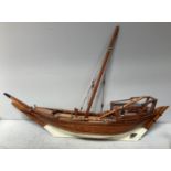 A planked and pinned model of a sailing ship with cream painted hull, approx. 120cm wide (af)