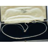 A lady's pearl necklace, graduated individually knotted pearls with diamond set white metal clasp,