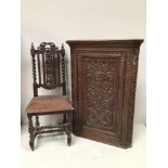 A hardwood hanging corner cupboard carved with stylised dragons to floral and foliate ground, 110