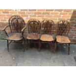 A matched set of 8 Oak wheel back dining chairs comprising of two carvers and 6 standard, turned