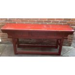 An early 20th century red stained, hard wood alter table, with three short frieze drawers with brass