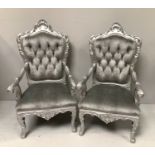 A pair of large ornate Louis XVI style armchairs painted in silver and recently upholstered in