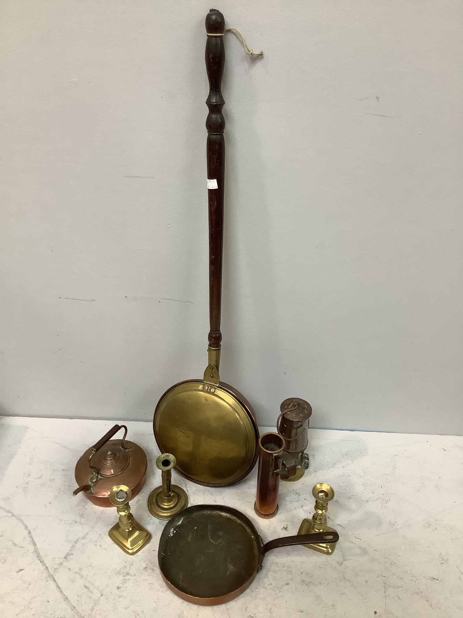 A copper skillet together with a copper kettle, a tall copper measure, Type 6 Eccles Miner's lamp,