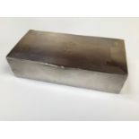 A silver and cedar lined cigarette box with engine turned decoration and monogrammed initials 'AWR',