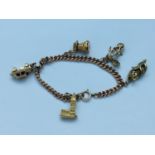 A 9ct gold multi charm bracelet, including car, koala bear, windmill and church, weighing 33.7