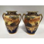 A pair of early 20th century Noritake porcelain twin-handled vases, painted with Bedouin scenes