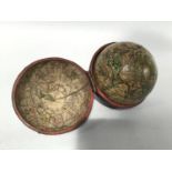 A fine 18th century English 2¾ inch pocket globe by John Senex, printed with a cartouche reading '