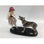 A Goldscheider pottery figure-group of a girl and a dog, raised on plinth base, impressed marks '