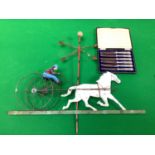 A metal decorative weather vane depicting a horse and carriage, 59cm high and 71cm wide together