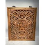 An early 20th century Chinese pierced and carved wooden panel, ornately worked with figures, birds