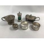 A small collection of assorted silver items comprising an Art Nouveau pepper with green glass
