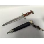 A WWII German Third Reich SA dagger and scabbard, the double edged blade engraved with makers