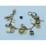 A 9ct gold charm bracelet with 19 x gold charms (one charm loose) including a penguin, an acorn, a