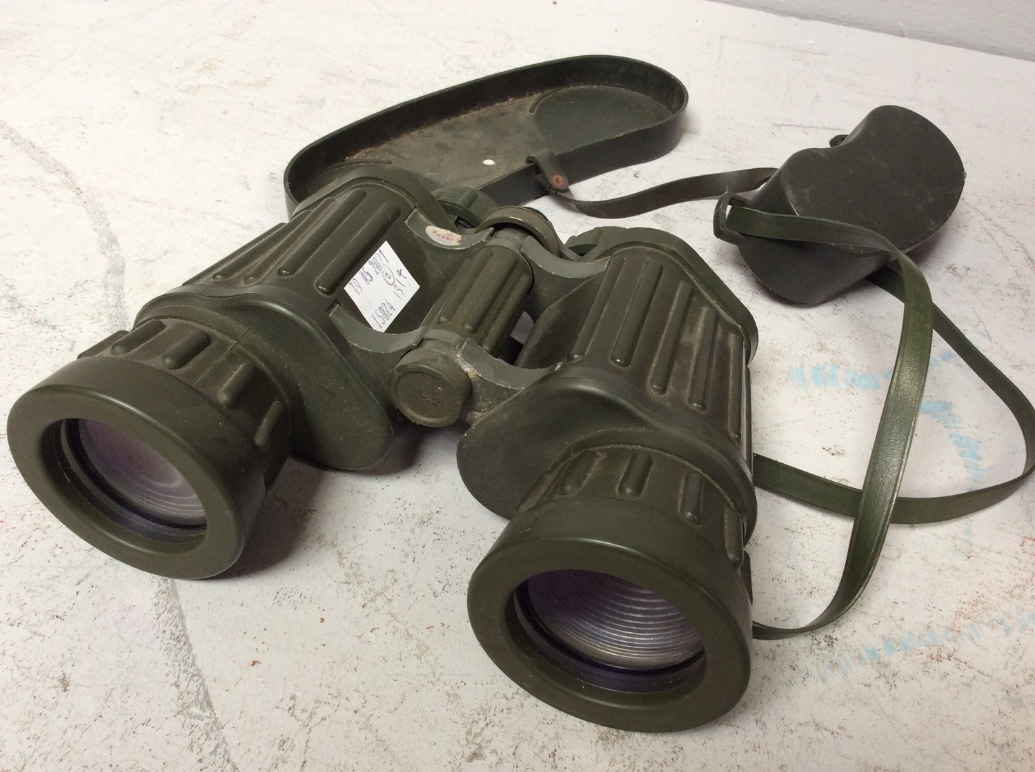 A pair of Tasco 311R model binoculars, 10x50mm, hard khaki green rubber finish with end caps,