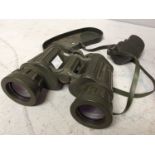 A pair of Tasco 311R model binoculars, 10x50mm, hard khaki green rubber finish with end caps,