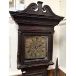 A carved oak 18th century longcase clock with swan neck pediment, floral carved pediment, raised