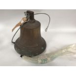 A bronze ship's bell and clapper with platted rope, cast in Portsmouth Dockyard foundry, 25cm (