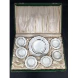An early 20th century set of seven silver caviar dishes decorated with white enamel and gilt fleur-