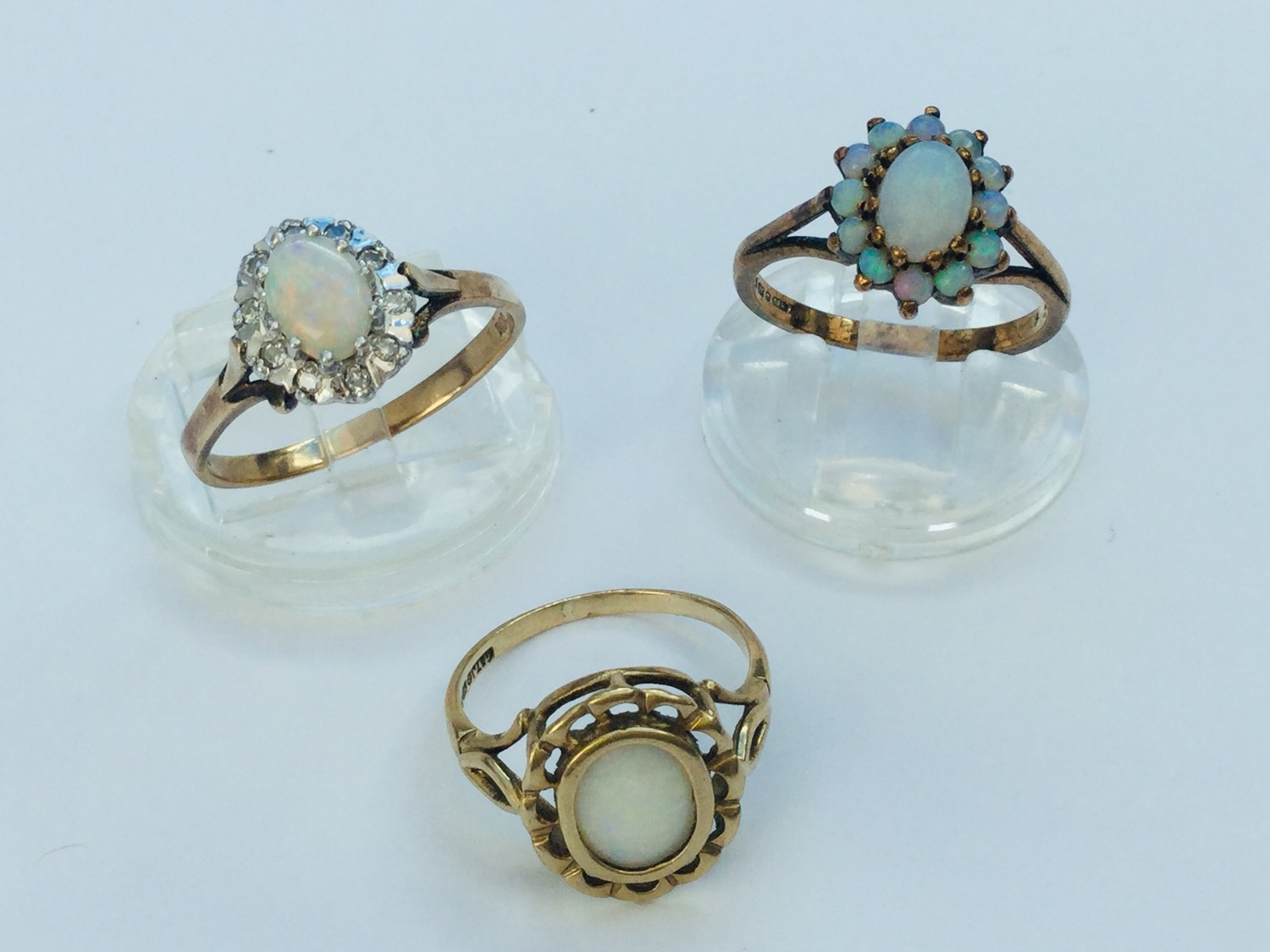 Three 9ct yellow gold opal dress rings, total weight 7.5 grams.